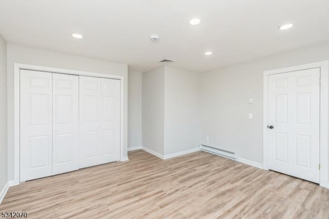 unfurnished bedroom with recessed lighting, light wood-style floors, baseboard heating, and visible vents