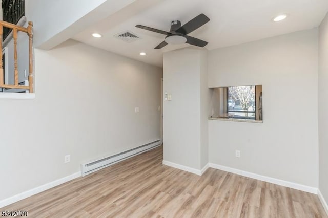 unfurnished room featuring baseboard heating, recessed lighting, visible vents, and wood finished floors