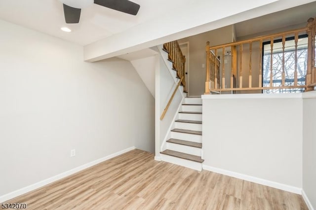 stairway with recessed lighting, baseboards, wood finished floors, and a ceiling fan