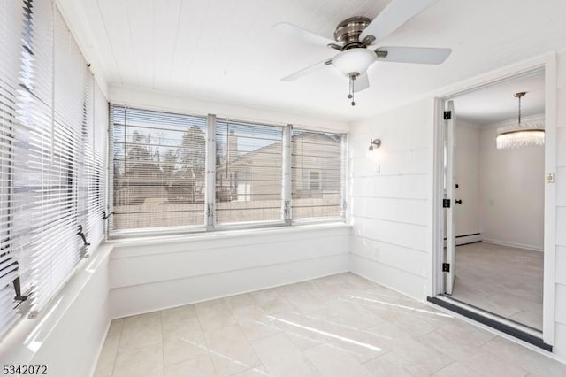 tiled empty room featuring a baseboard heating unit and ceiling fan