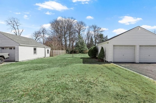 view of yard featuring an outdoor structure and a detached garage