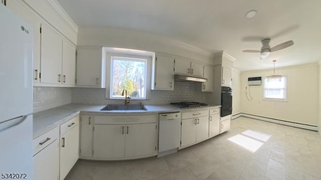 kitchen featuring a sink, a baseboard heating unit, under cabinet range hood, white appliances, and light countertops