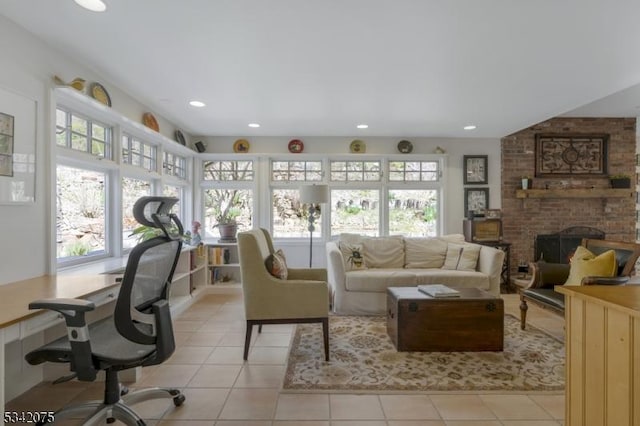 living room with recessed lighting, light tile patterned floors, a fireplace, and plenty of natural light