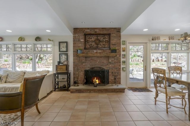 living room featuring a brick fireplace, recessed lighting, and light tile patterned flooring