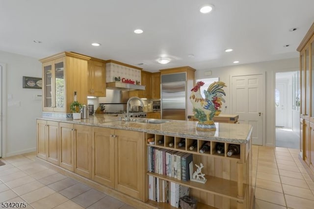 kitchen featuring open shelves, built in refrigerator, light stone countertops, and light tile patterned floors