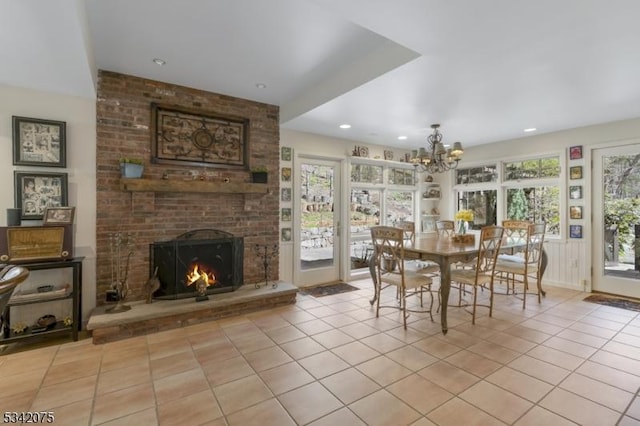 dining space with light tile patterned flooring, a chandelier, and plenty of natural light