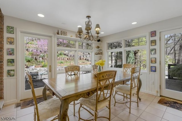 dining space with an inviting chandelier, a healthy amount of sunlight, light tile patterned flooring, and recessed lighting