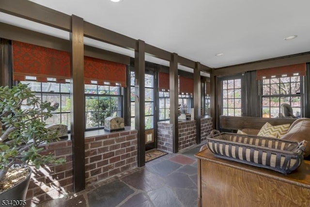 living area featuring stone floors and recessed lighting