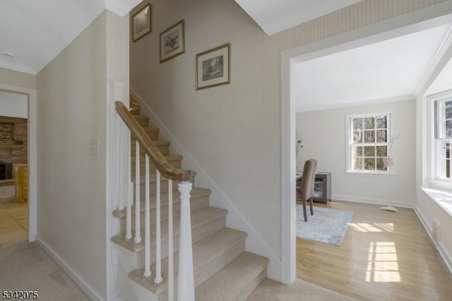 stairway featuring baseboards and wood finished floors