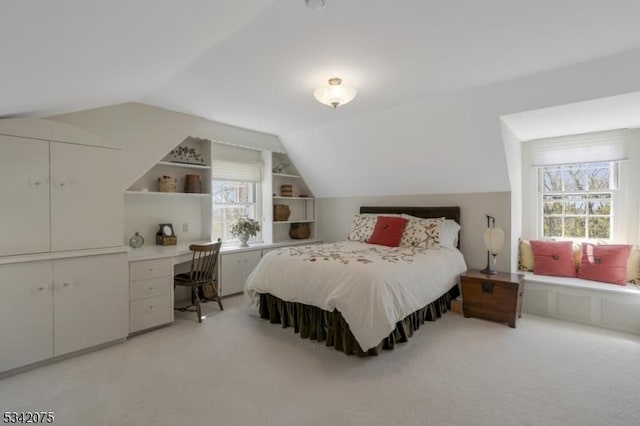 bedroom featuring light carpet and vaulted ceiling