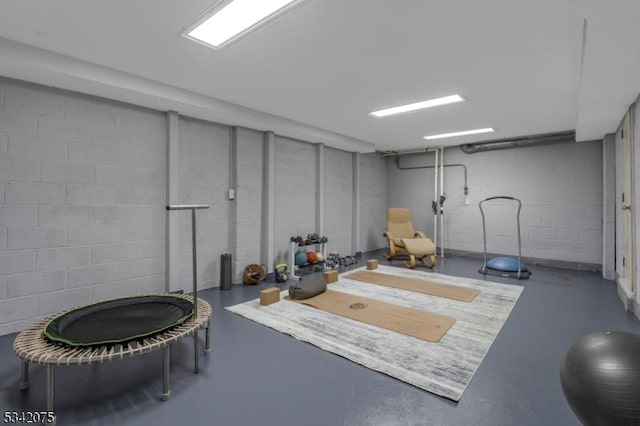 workout room featuring concrete block wall