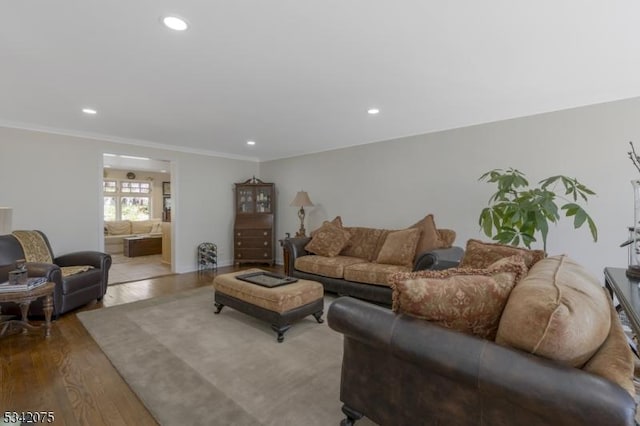 living area featuring recessed lighting, wood finished floors, and ornamental molding