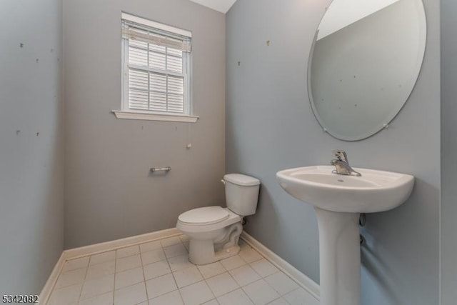 bathroom featuring baseboards, toilet, and tile patterned floors