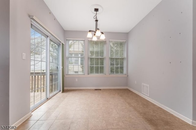 unfurnished dining area featuring visible vents, a notable chandelier, baseboards, and light tile patterned flooring