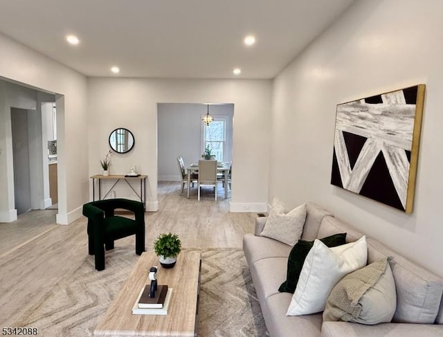 living area featuring light wood-style flooring, baseboards, and recessed lighting