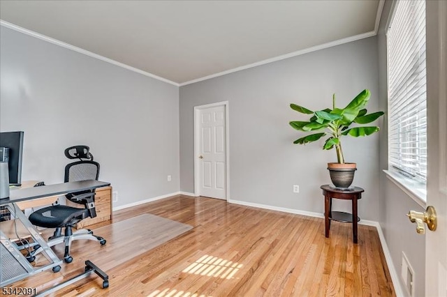 office space with visible vents, baseboards, crown molding, and wood finished floors