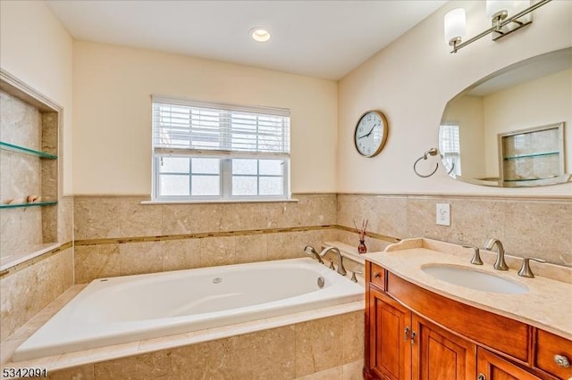 bathroom with a garden tub and vanity