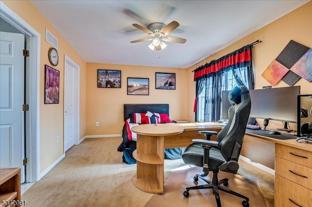 office area featuring light colored carpet, ceiling fan, visible vents, and baseboards