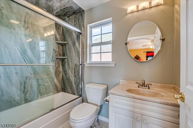 bathroom with toilet, combined bath / shower with glass door, and vanity