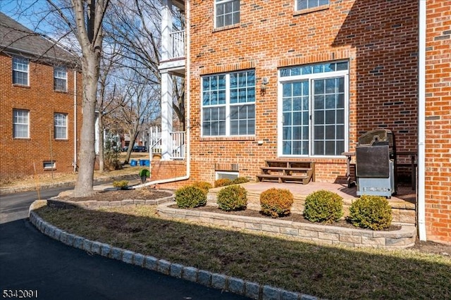 property entrance featuring brick siding