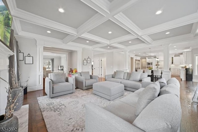 living area featuring beam ceiling, coffered ceiling, and ornate columns