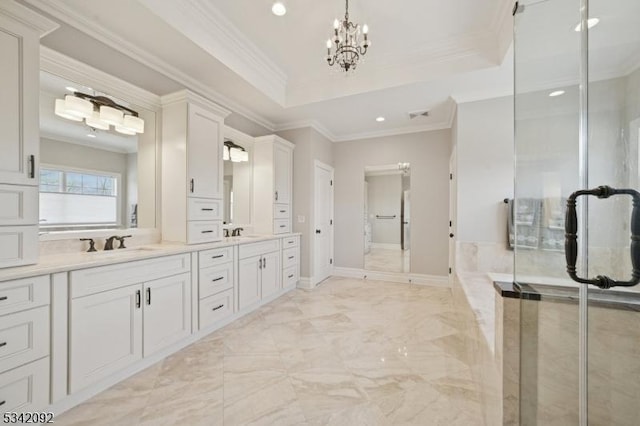 full bath with double vanity, a tray ceiling, a sink, and crown molding