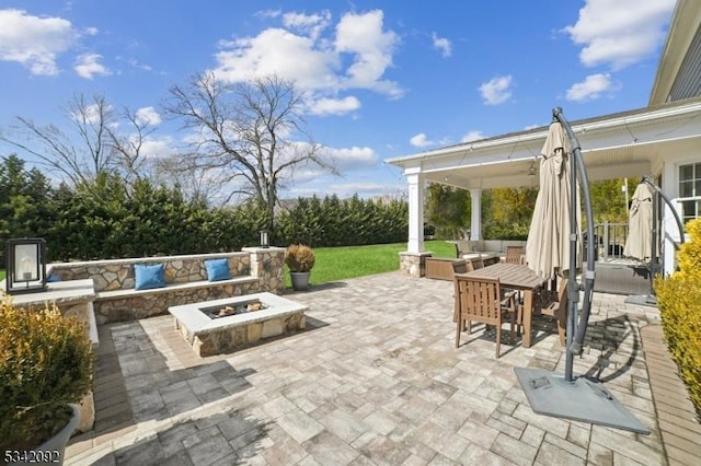 view of patio / terrace with an outdoor fire pit and outdoor dining space