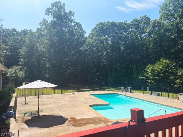 view of swimming pool with a patio, fence, and a fenced in pool