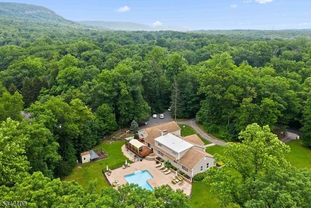 birds eye view of property with a wooded view