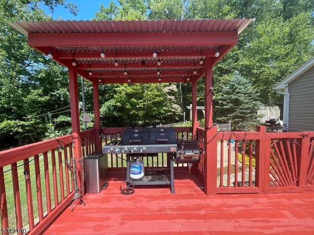 wooden deck featuring a grill