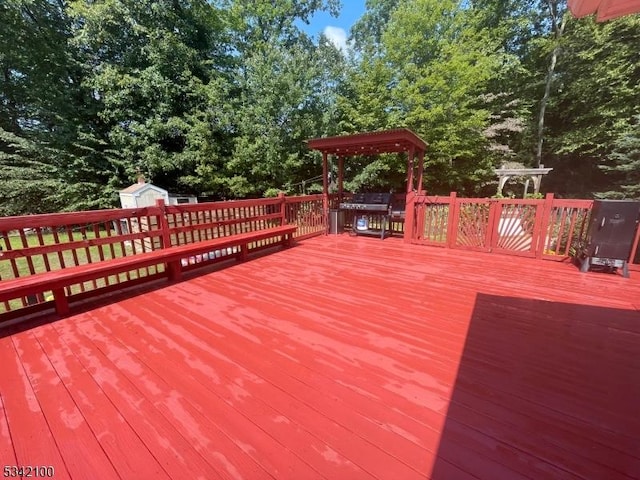 deck featuring an outdoor structure and a shed