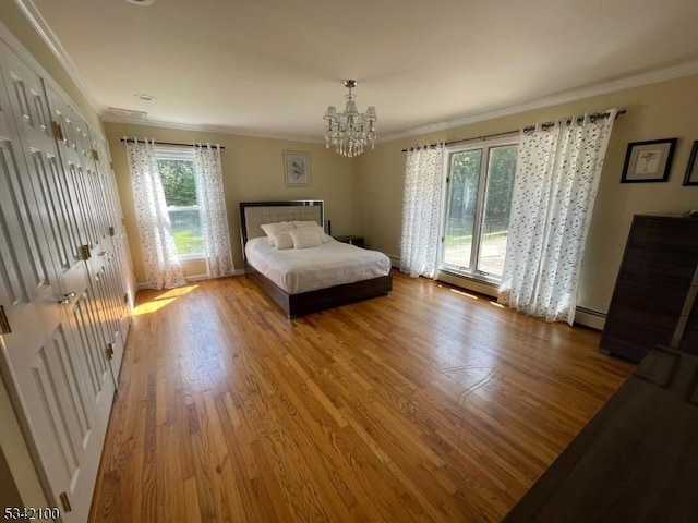 bedroom with ornamental molding, baseboard heating, an inviting chandelier, and wood finished floors