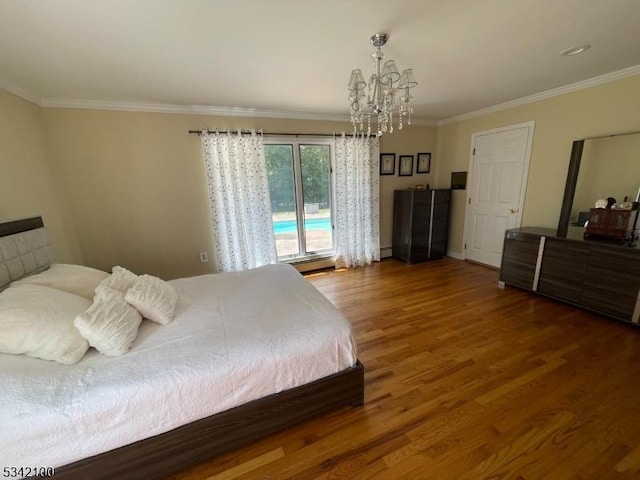 bedroom featuring a chandelier, a baseboard radiator, crown molding, and wood finished floors