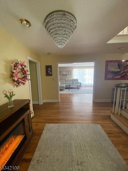 hallway with baseboards and wood finished floors