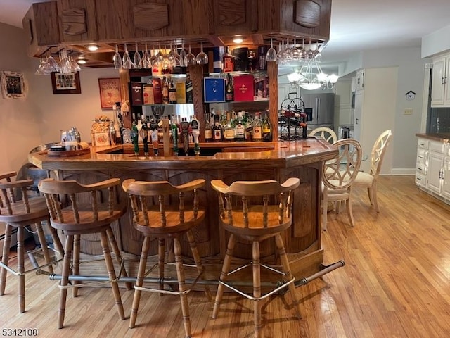 bar with light wood-style floors