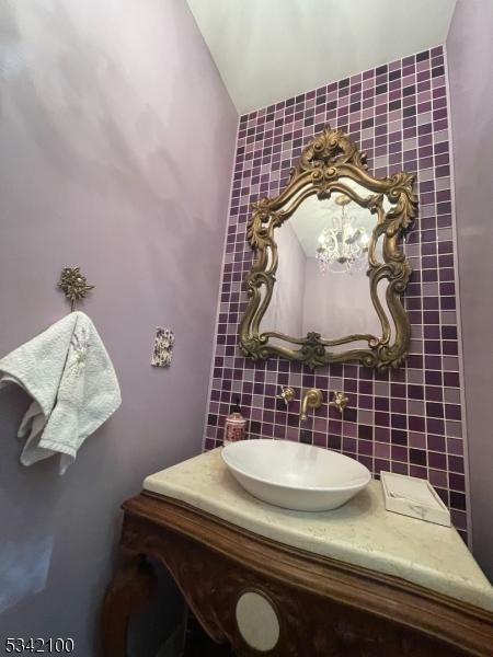 bathroom featuring backsplash and a sink