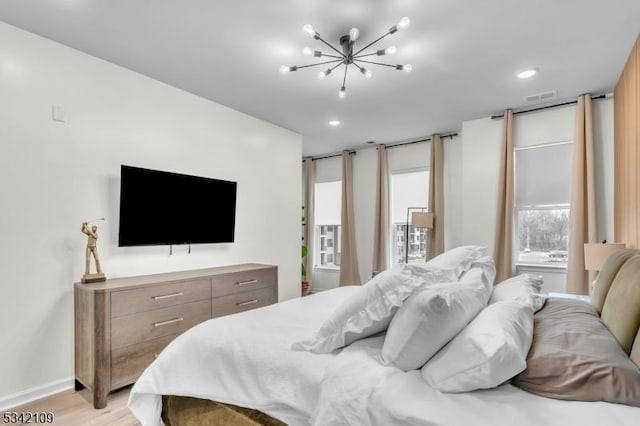 bedroom with baseboards, visible vents, an inviting chandelier, light wood-type flooring, and recessed lighting