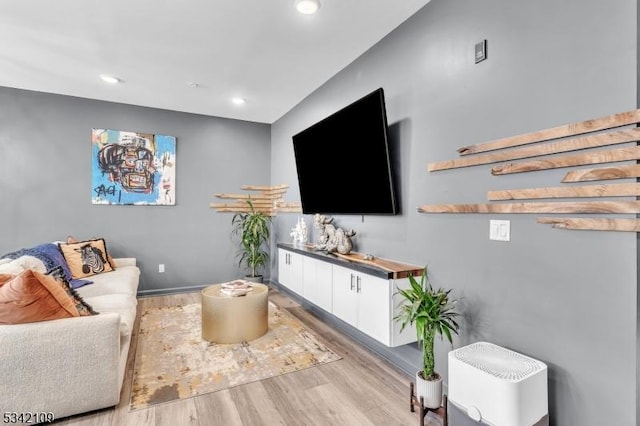 living area featuring light wood finished floors and recessed lighting