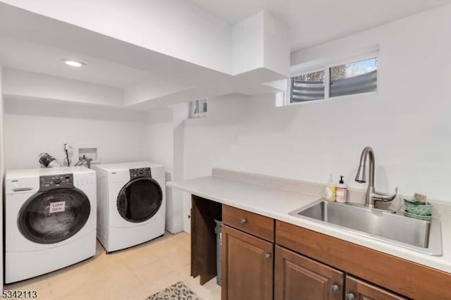 clothes washing area featuring washer and clothes dryer, a sink, cabinet space, and recessed lighting