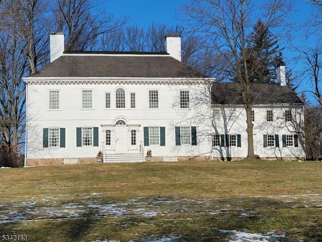 view of front of house featuring a front yard and a chimney