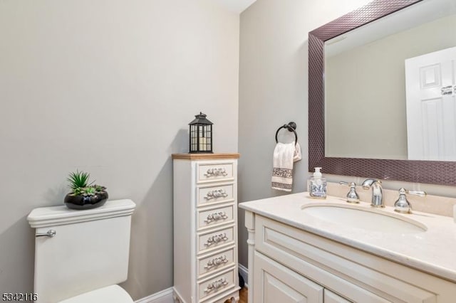 half bath featuring toilet and vanity