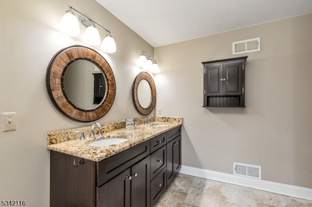 bathroom with a sink, visible vents, and baseboards