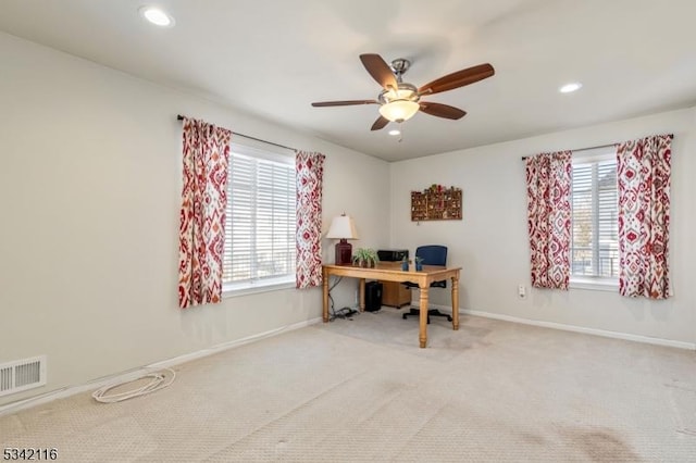 carpeted office space featuring a ceiling fan, recessed lighting, baseboards, and visible vents