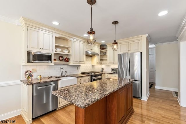 kitchen featuring open shelves, ornamental molding, a sink, under cabinet range hood, and appliances with stainless steel finishes