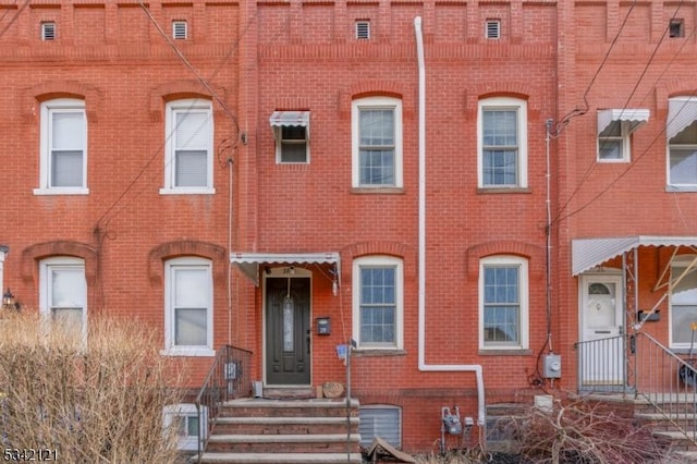 townhome / multi-family property with brick siding