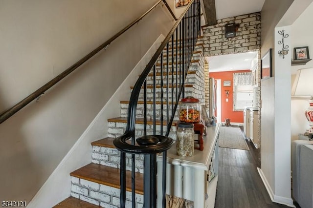 stairway with baseboards and wood finished floors