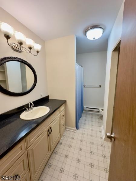 full bathroom featuring baseboards, a baseboard radiator, vanity, and tile patterned floors