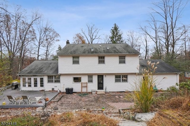 back of property with a patio and a chimney