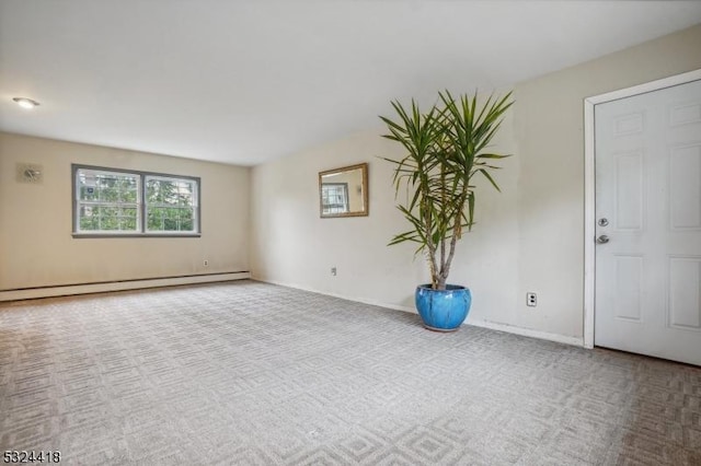 spare room with a baseboard radiator, carpet, and baseboards