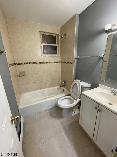 bathroom with vanity, toilet, shower / bathtub combination, and tile patterned flooring